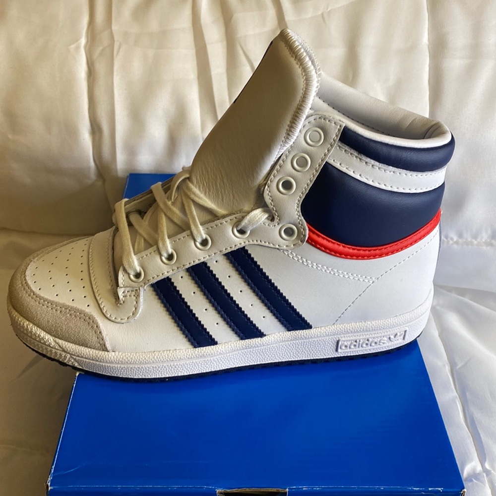 Boys white high top Adidas’s w/ blue stripes and blue and red accents on back